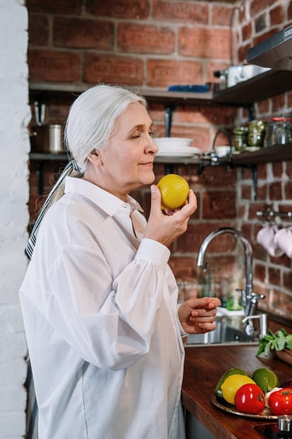 woman sniffing a lemon