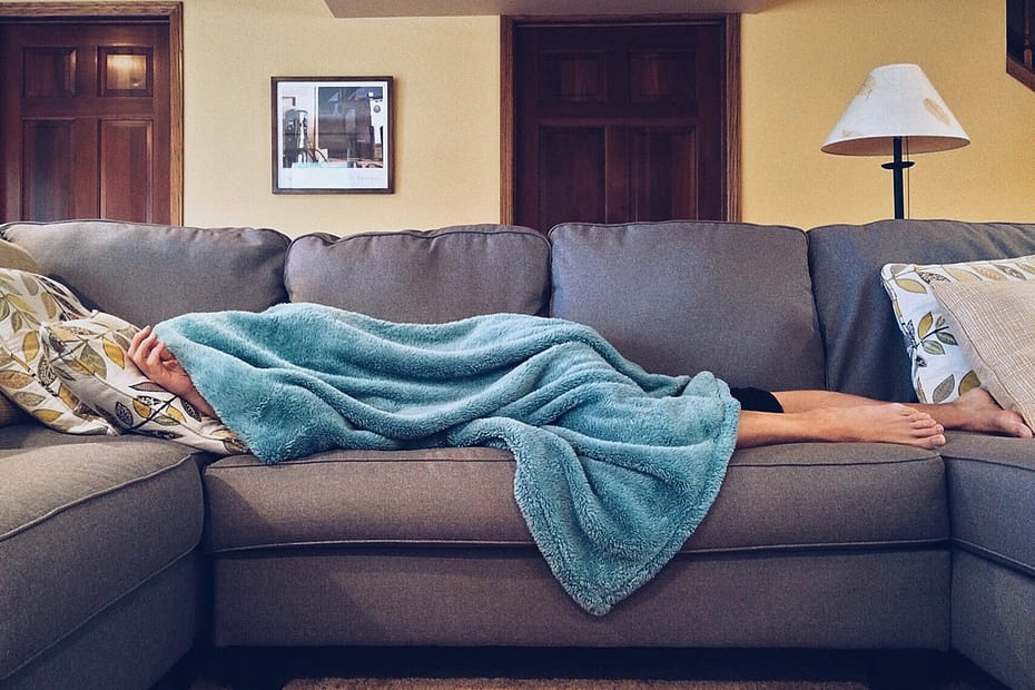 photo of exhausted person lying on sofa